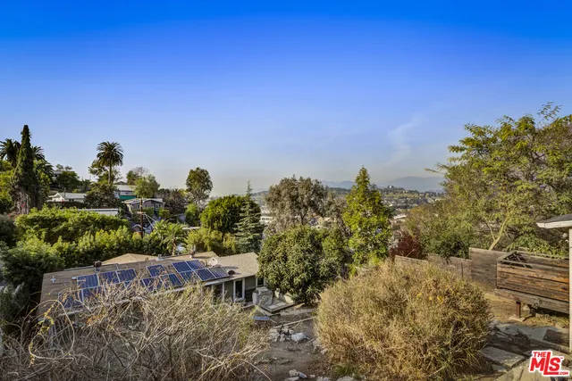 a wooden bridge with lake in front of it