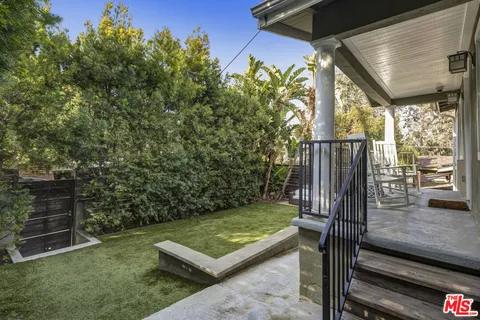 a view of a two chairs in the patio