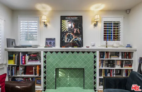a living room with furniture and a book shelf