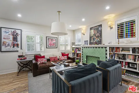 a living room with furniture a window and bookshelf