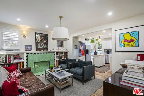 a living room with furniture fireplace and a large window