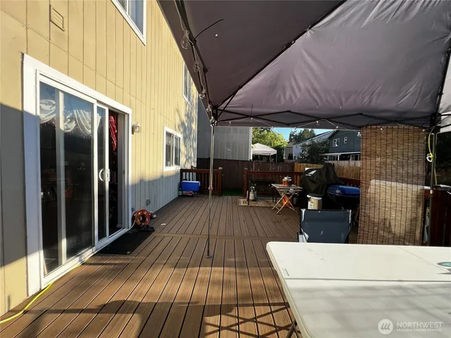 a view of a porch with wooden floor and furniture