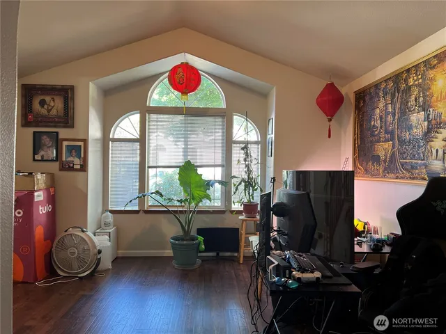 a view of a workspace with furniture and a window
