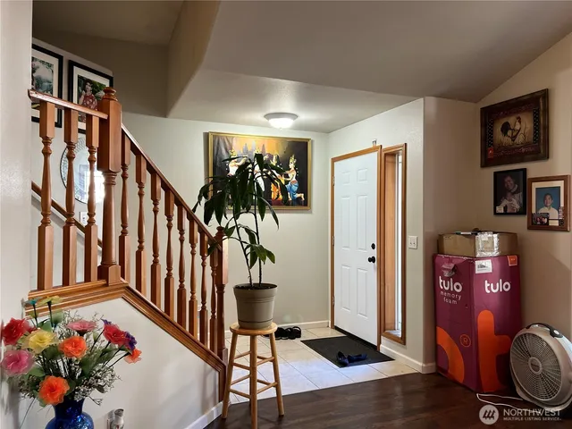 a view of an entryway with wooden floor