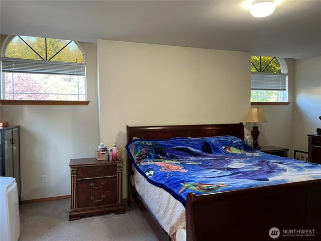 a bed sitting in a room next to a window