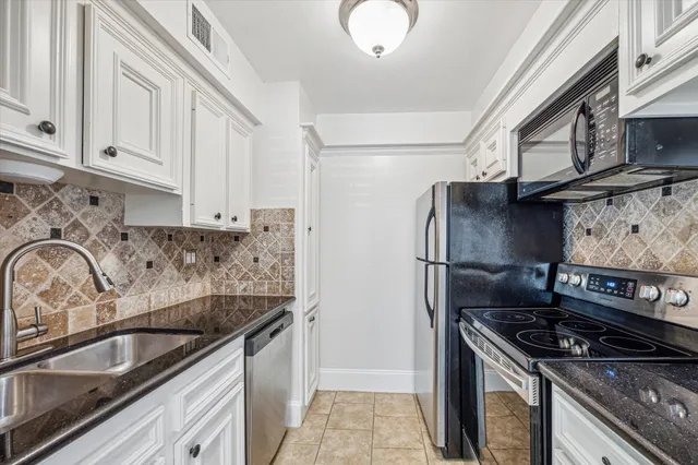 a bedroom with a large bed and a tv