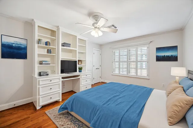 an empty room with cabinet and windows