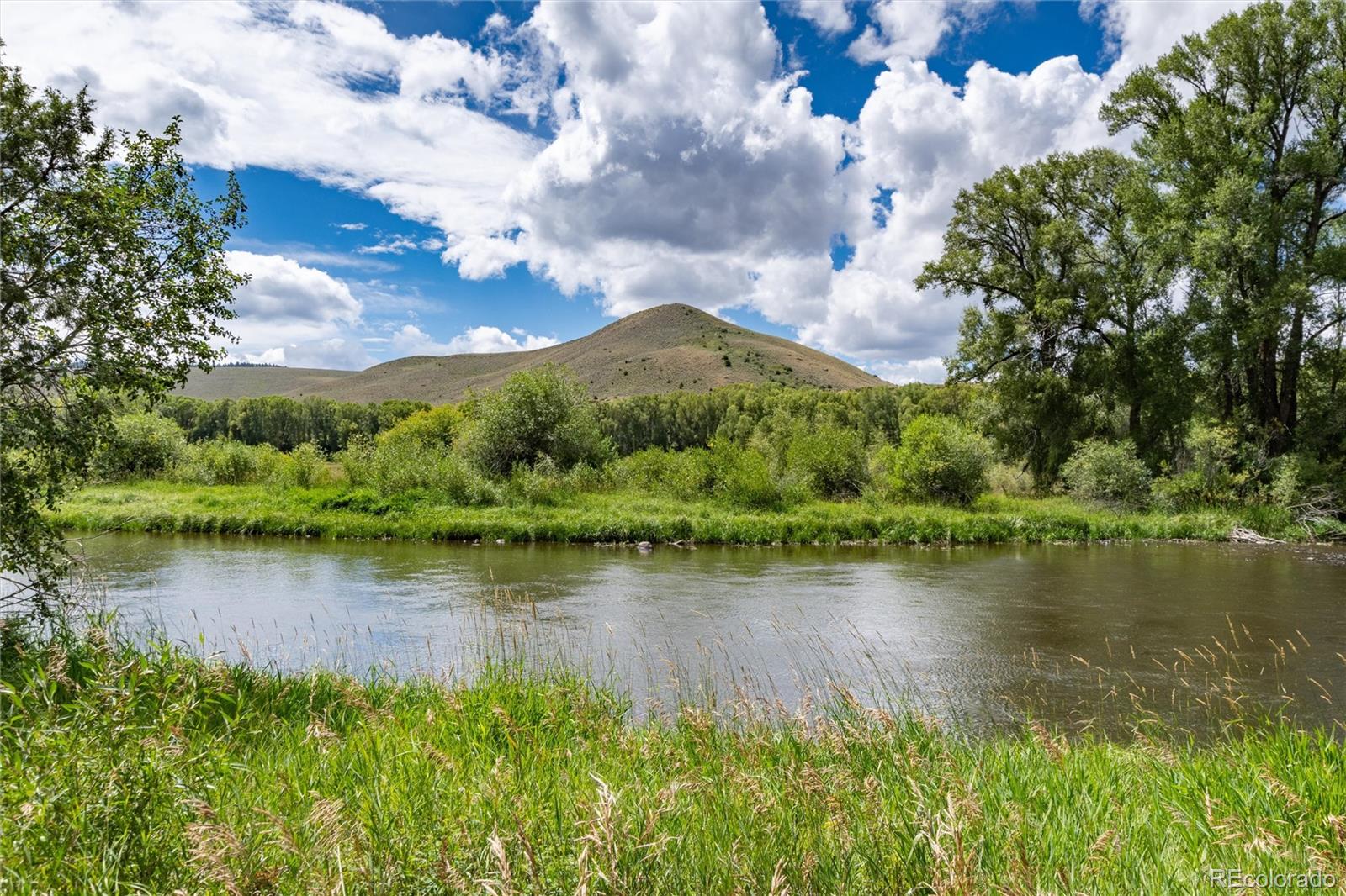 125 Main Street Parshall, CO 80468 - Photo 15 of 47 a view of a lake with a house in the background