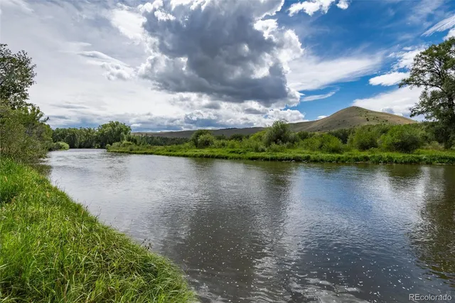 a view of a lake with houses in the back