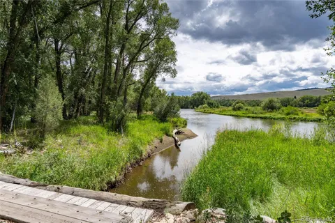 a view of a lake with houses in the back