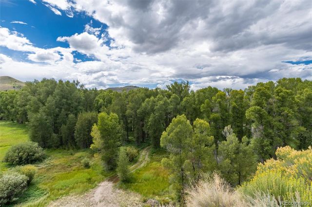 a aerial view of a houses with yard