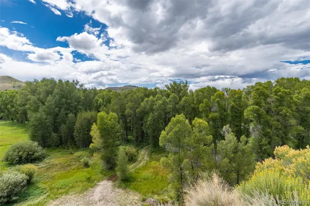 a aerial view of a houses with yard