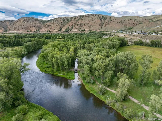 an aerial view of a house with a yard