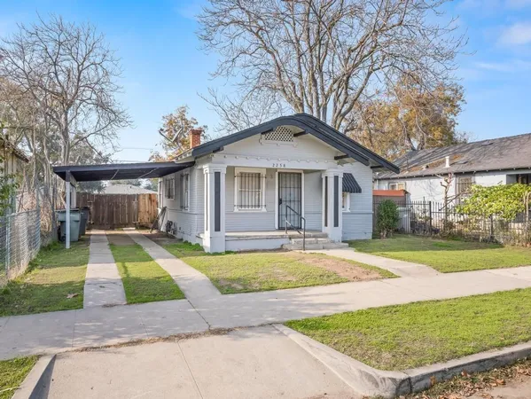 a front view of a house with a yard table and chairs