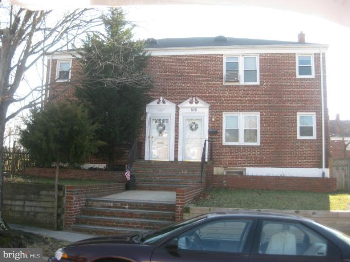 1117 Cedarcroft Road Baltimore, MD 21239 - Photo 1 of 11 a front view of a house with a yard