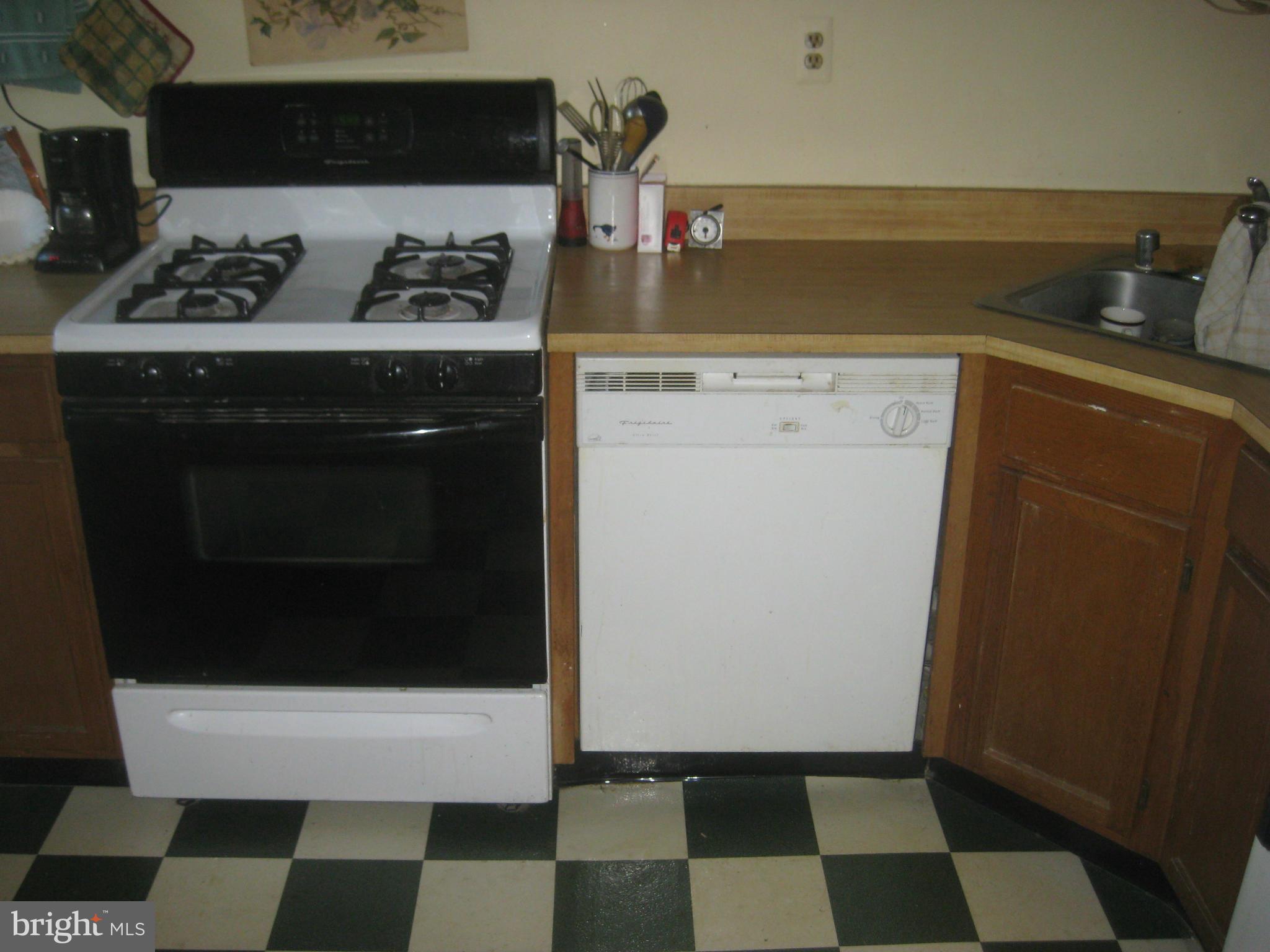 1117 Cedarcroft Road Baltimore, MD 21239 - Photo 3 of 11 a kitchen with a stove and a refrigerator