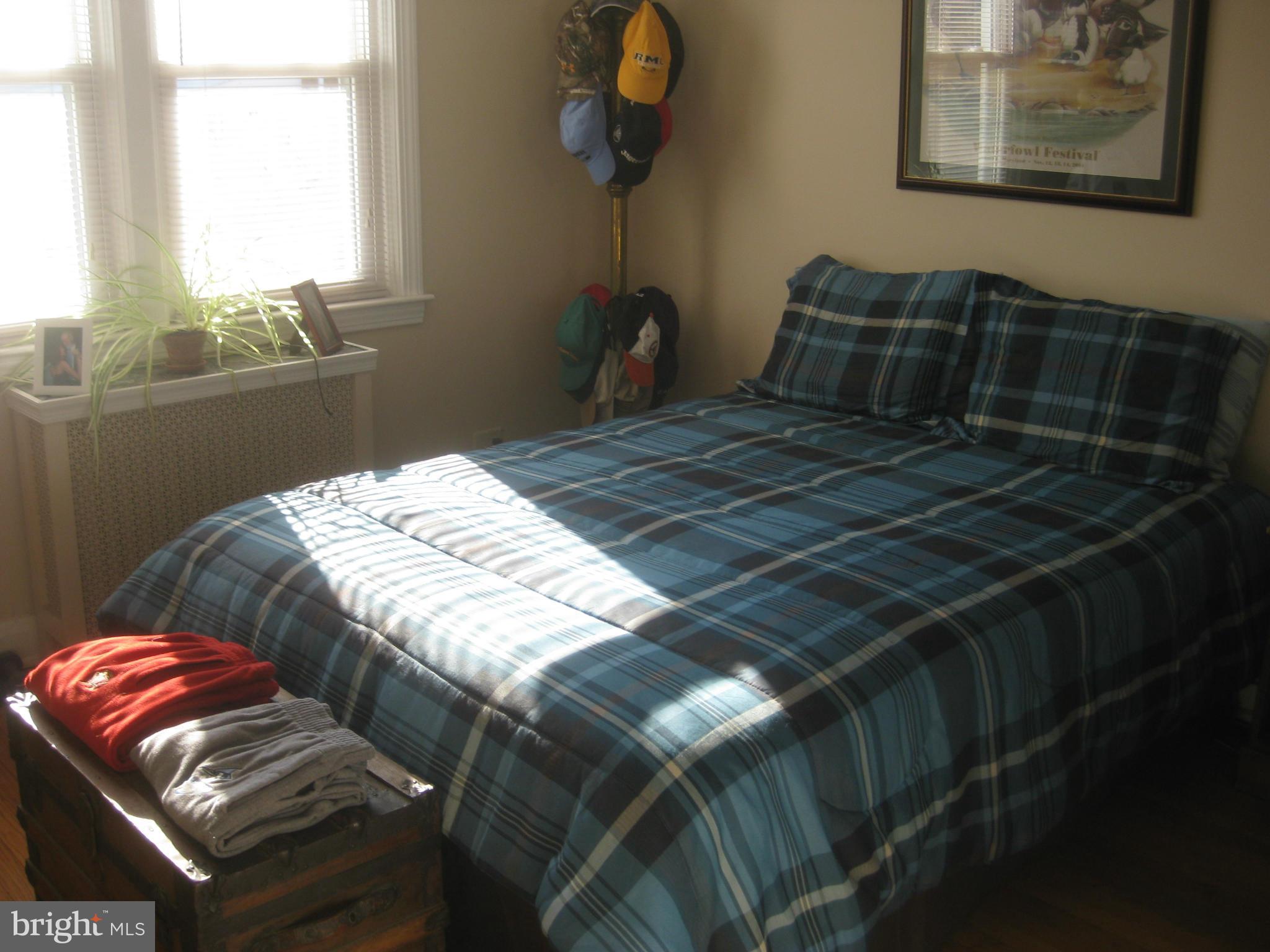 1117 Cedarcroft Road Baltimore, MD 21239 - Photo 4 of 11 a bedroom with a bed and a window
