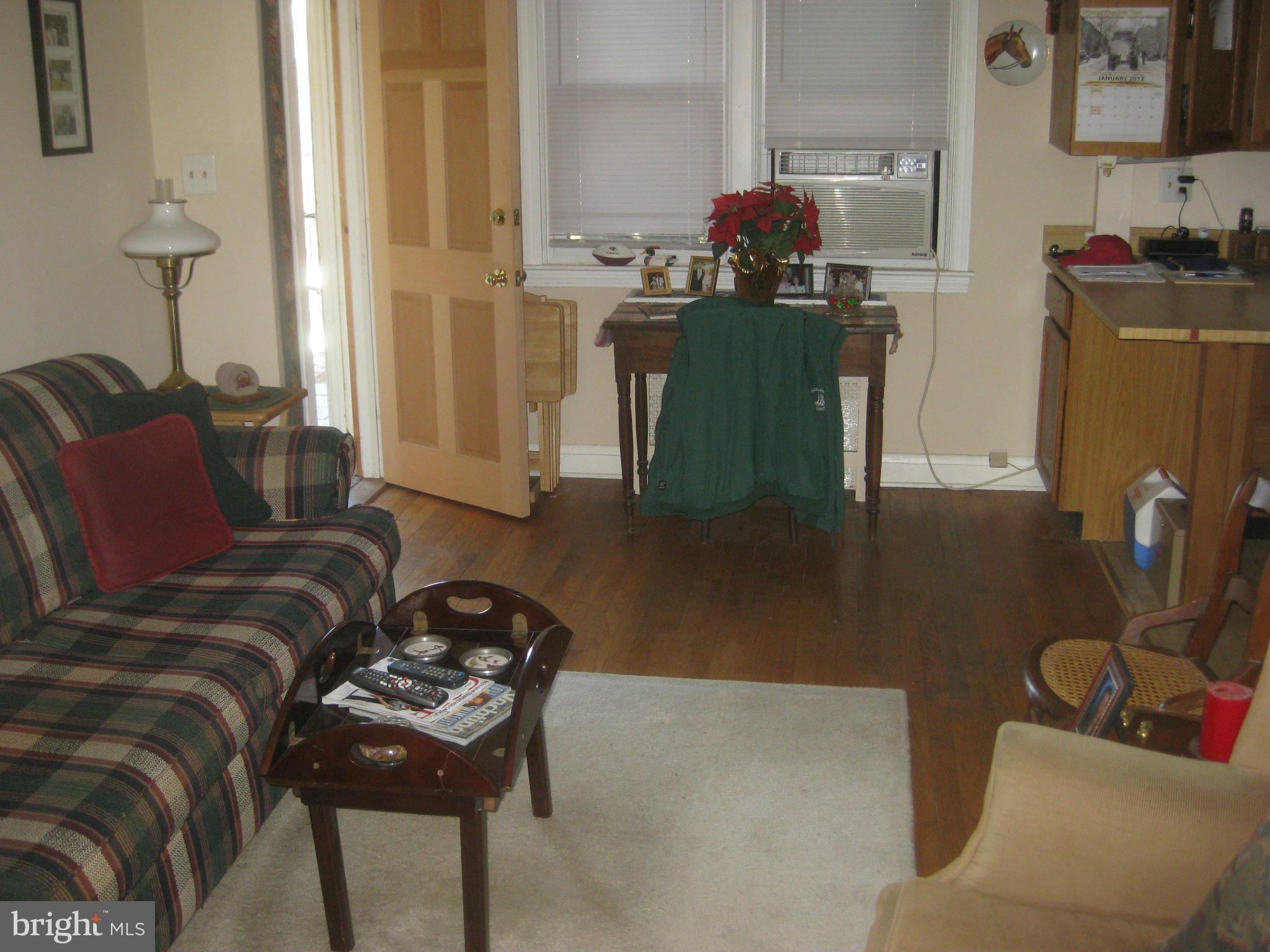 1117 Cedarcroft Road Baltimore, MD 21239 - Photo 6 of 11 a living room with furniture and a flat screen tv