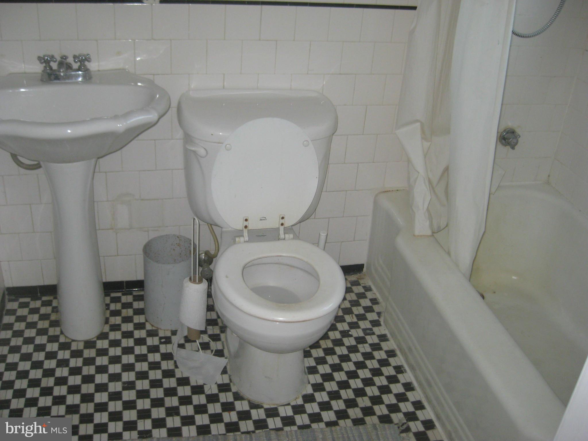 1117 Cedarcroft Road Baltimore, MD 21239 - Photo 8 of 11 a bathroom with a sink toilet and shower