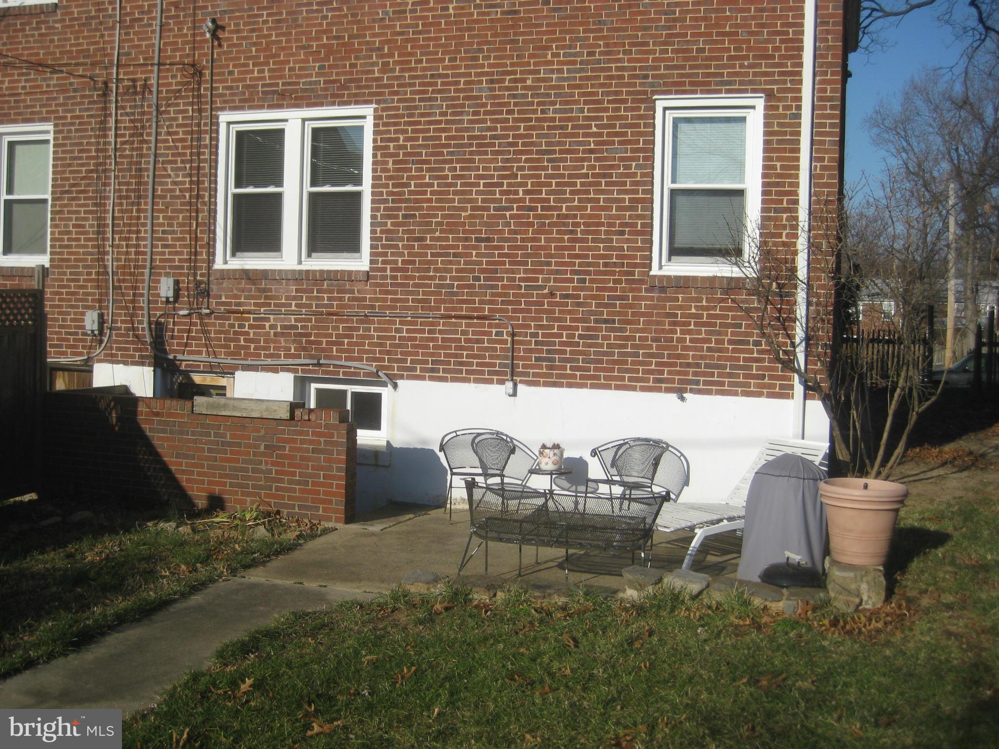 1117 Cedarcroft Road Baltimore, MD 21239 - Photo 10 of 11 a front view of a house with outdoor seating