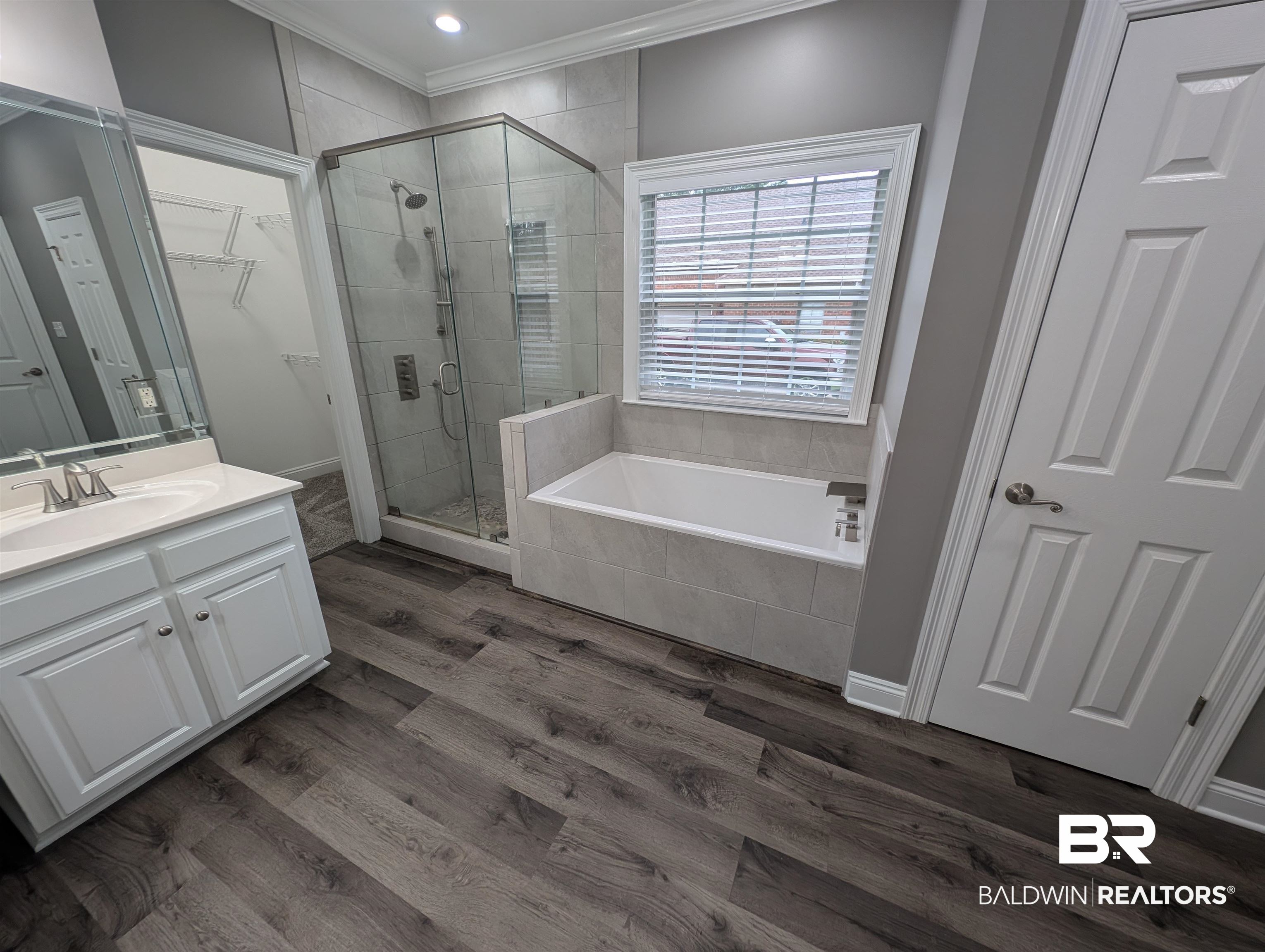 11623 Halcyon Loop Daphne, AL 36526 - Photo 62 of 90 Bathroom featuring wood-type flooring, vanity, plus walk in shower, garden tub, and separated toilet closet