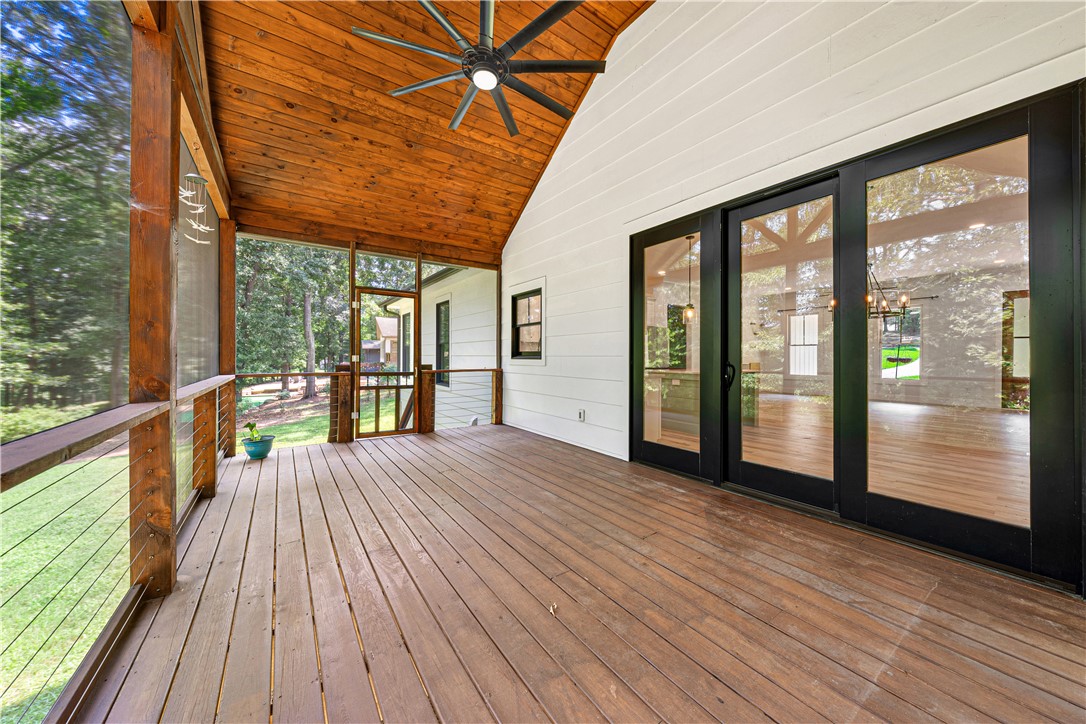 516 Winding Way Hartwell, GA 30643 - Photo 23 of 50 A spacious screened porch with vaulted wood ceilings offers a serene outdoor living space, ideal for enjoying nature.