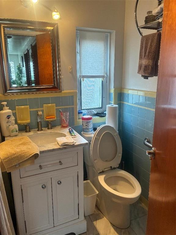 1238 Love Street Pittsburgh, PA 15218 - Photo 8 of 16 a bathroom with a granite countertop toilet sink and mirror