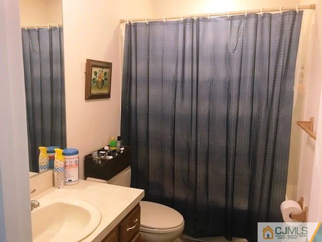 1 Sunflower Court Edison, NJ 08820 - Photo 12 of 15 a bathroom with a sink vanity and toilet