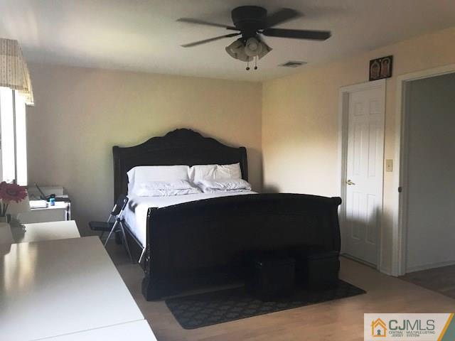 1 Sunflower Court Edison, NJ 08820 - Photo 13 of 15 a bedroom with a bed and a hallway