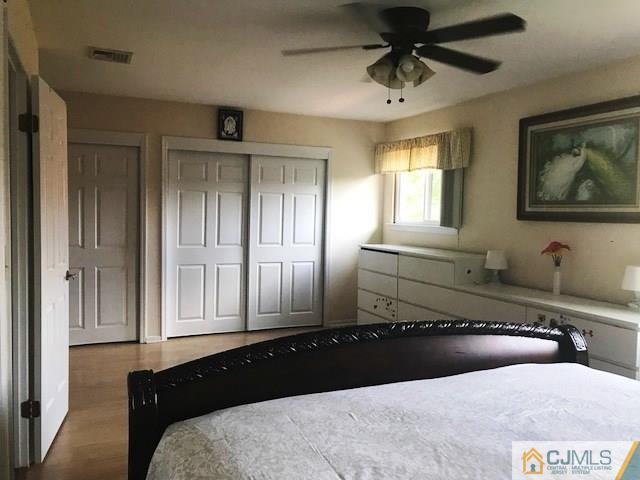 1 Sunflower Court Edison, NJ 08820 - Photo 14 of 15 a bedroom with a bed and a chandelier