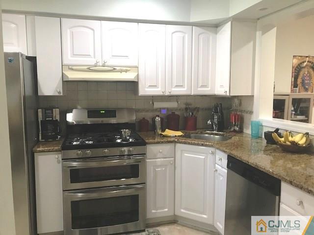 1 Sunflower Court Edison, NJ 08820 - Photo 6 of 15 a kitchen with stainless steel appliances granite countertop a sink stove and refrigerator