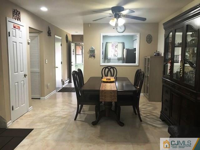 1 Sunflower Court Edison, NJ 08820 - Photo 7 of 15 a view of a dining room with furniture and a chandelier