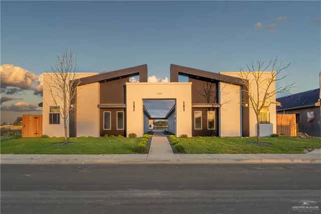 a front view of a house with a garden and pathway