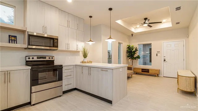 a kitchen with stainless steel appliances a stove a sink and a refrigerator