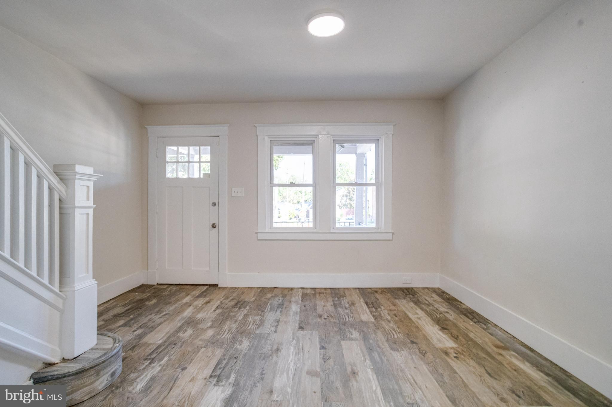 5878 Belair Road Baltimore, MD 21206 - Photo 28 of 41 an empty room with wooden floor and windows