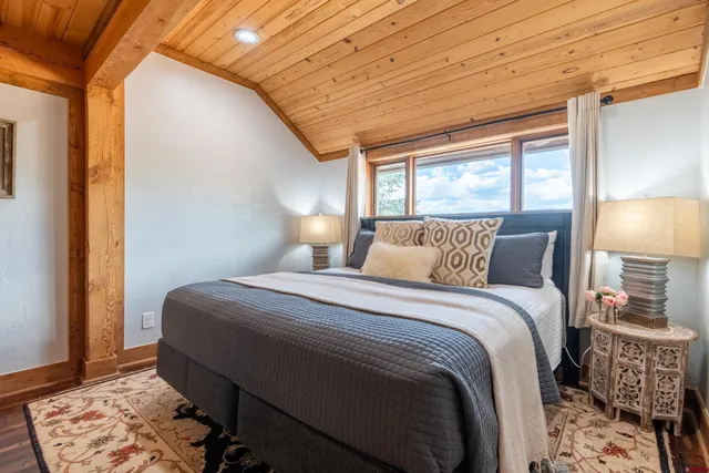 a bedroom with a bed and a mirror