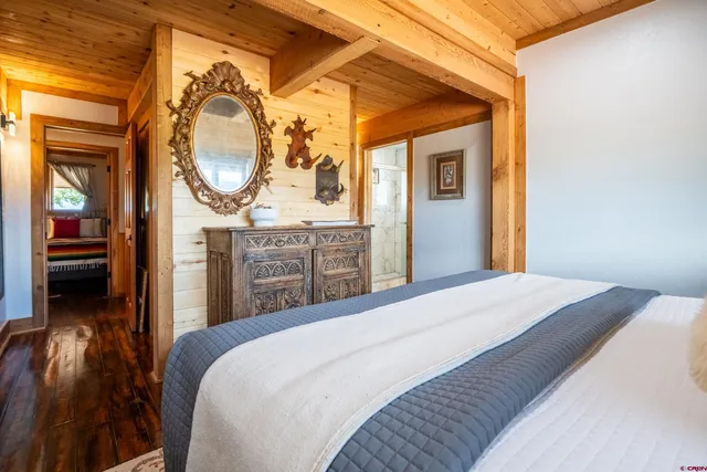 a bathroom with a granite countertop toilet sink and mirror