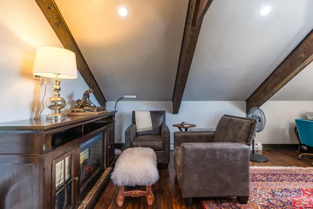 a bathroom with a sink a toilet a mirror and shower