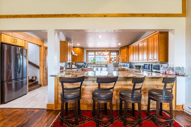 a dining area with furniture and a large window