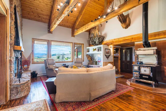a living room with furniture a window and kitchen view