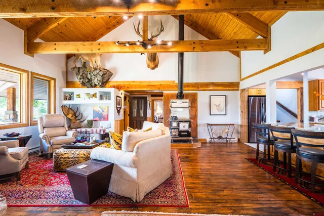 a living room with furniture a rug and a table