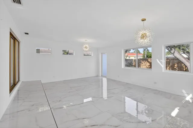 a view of a livingroom with wooden floor and furniture