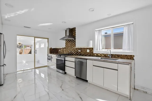 a spacious bathroom with a granite countertop sink a mirror and a vanity