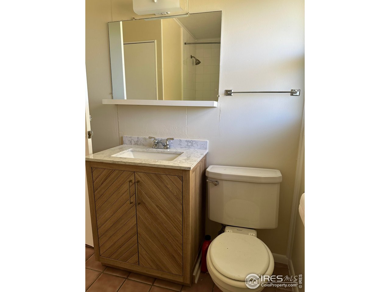 2324 19th Street Boulder, CO 80304 - Photo 12 of 33 a bathroom with a toilet a sink and mirror