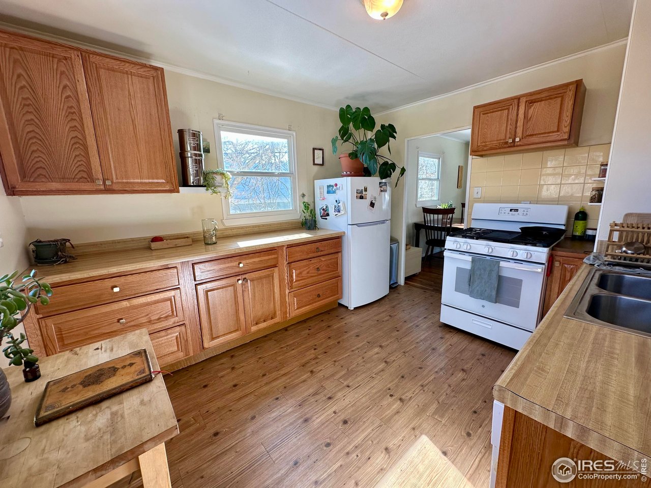 2324 19th Street Boulder, CO 80304 - Photo 6 of 33 a kitchen with wooden floors and appliances