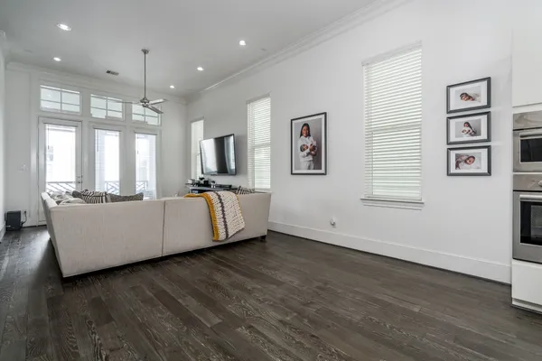 a living room with couches and painting on the wall