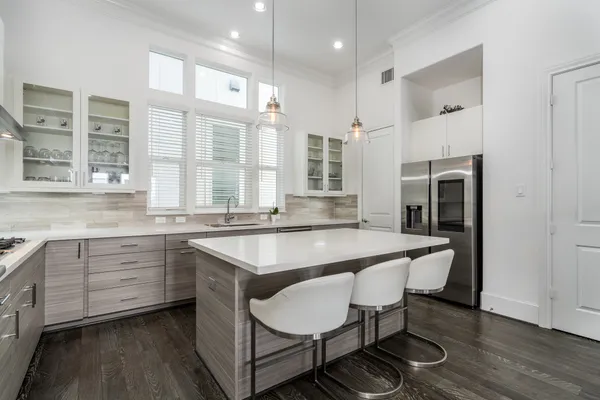 a large white kitchen with a large window