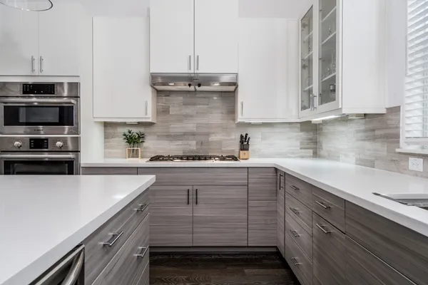 a kitchen with cabinets appliances and a counter space