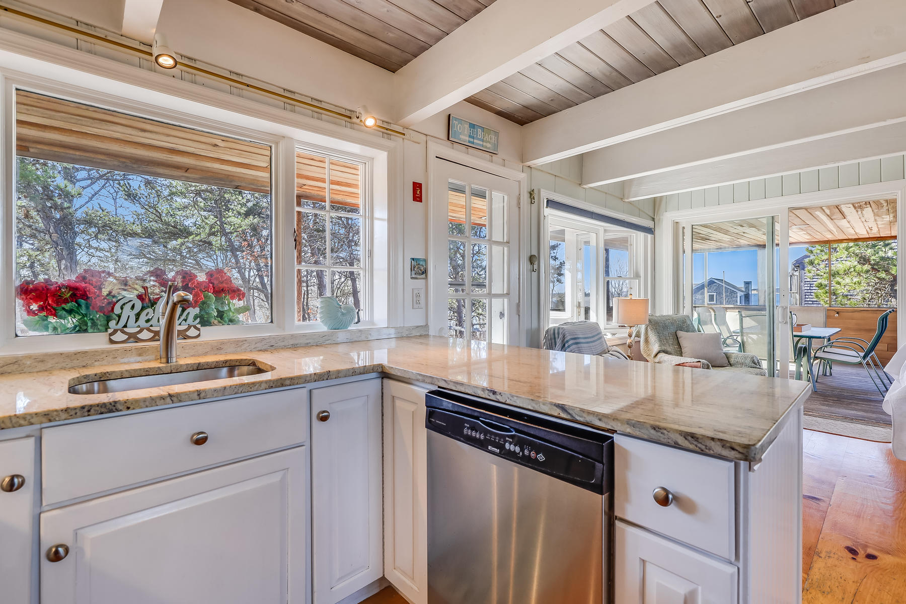 155 Nauhaught Bluff Road Wellfleet, MA 02667 - Photo 12 of 53 a kitchen with stainless steel appliances granite countertop a sink and cabinets