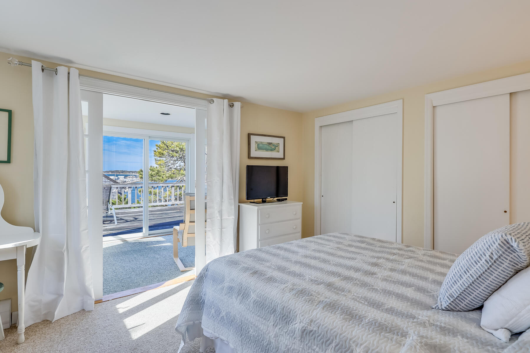 155 Nauhaught Bluff Road Wellfleet, MA 02667 - Photo 20 of 53 a bedroom with a bed and a flat screen tv